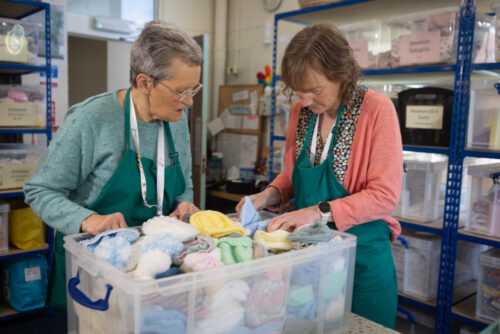 A photo of voluneteers packing a box.